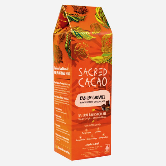 Carton of Sacred Cacao Cashew Caramel chocolate on a white background. Angle view.